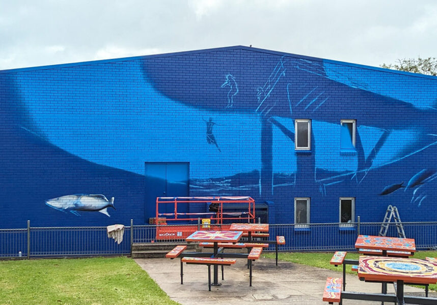 mural-commenced-on-big-blue-wall-2